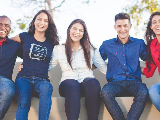 photo of diverse young adults sitting on a sofa